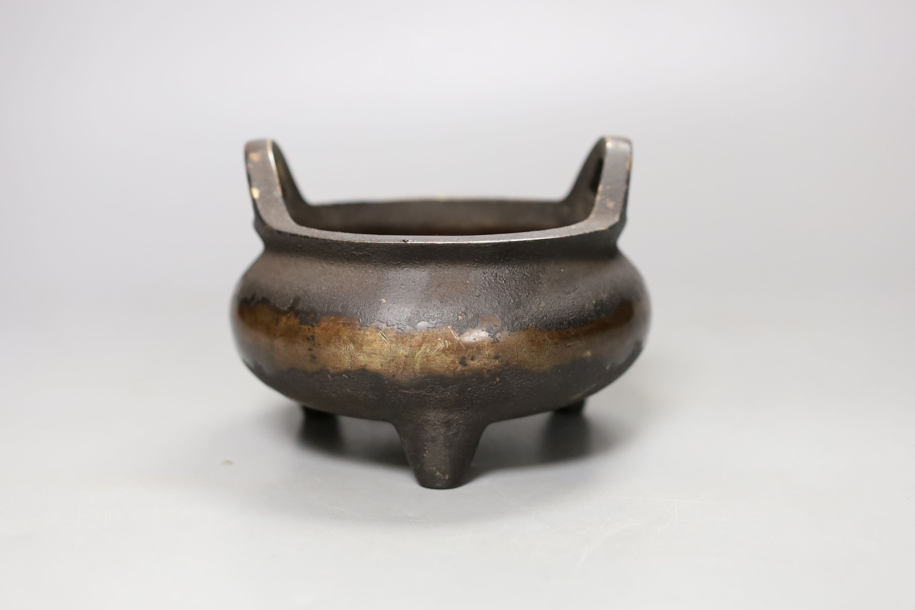 A Chinese bronze tripod censer, Xuande mark, 14 cm wide